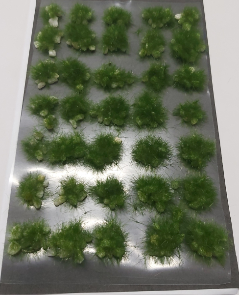 Tufts of grass on light stones summer